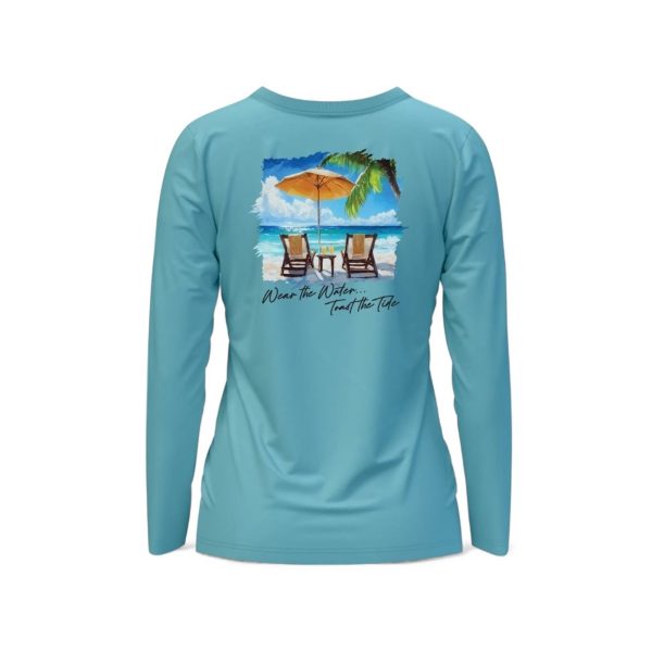 Women's Toast the Tide long sleeve performance shirt. Tropical beach scene with chairs
